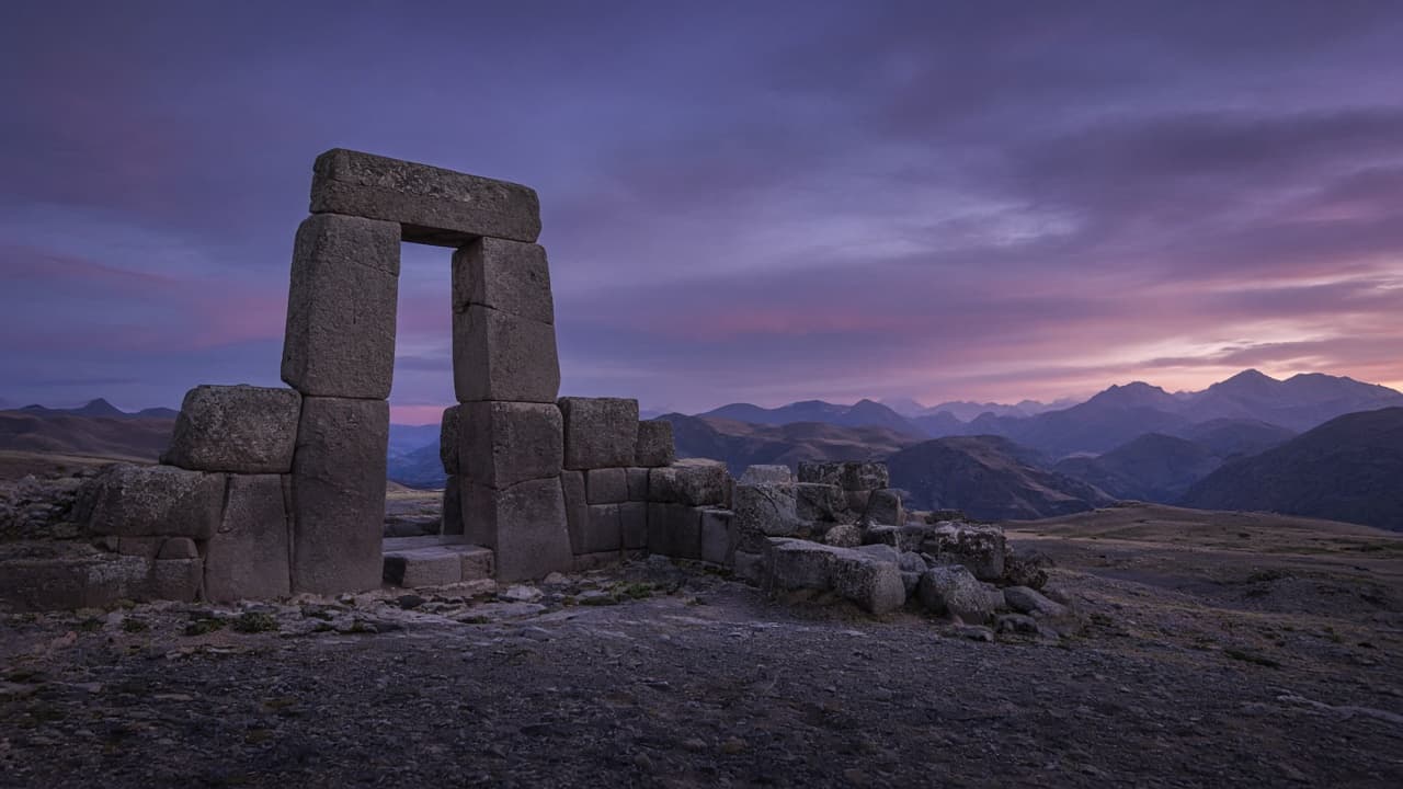 Ancient megalithic stone gateway on a high plateau at dusk